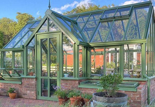 Luxury plant room inside a wrought iron conservatory filled with tropical plants