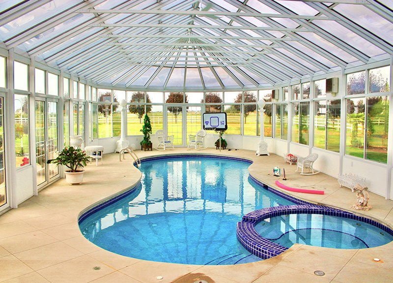 Full Pool Enclosure -- iron and glass structure completely covering a swimming pool